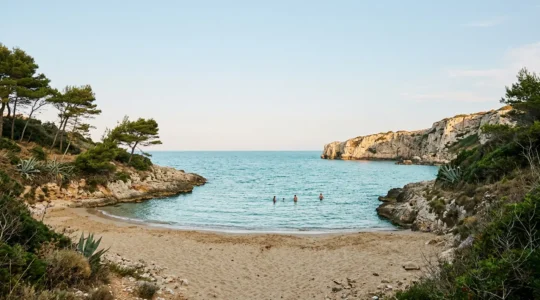 Una caletta italiana tranquilla con acqua cristallina e pochi bagnanti, immersa nella natura mediterranea